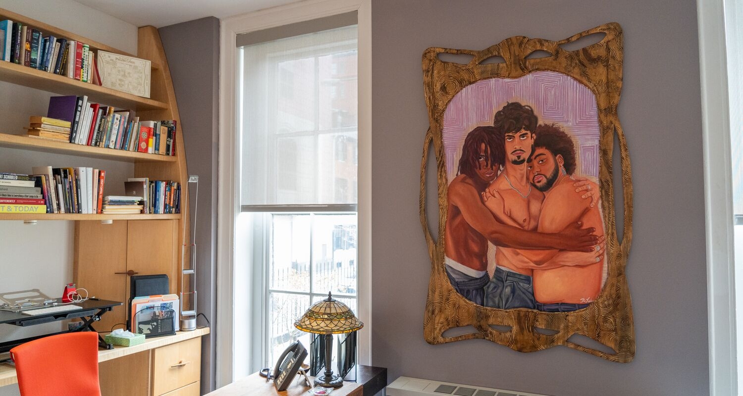 interior of the president's office with a large painting depicting queer affection hanging over a desk. 