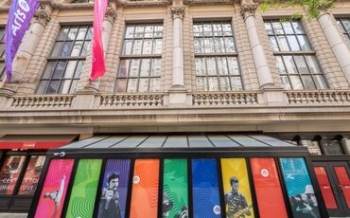 Terra Hall decorated with colorful banners that include images of students from all disciplines and the UArts logo