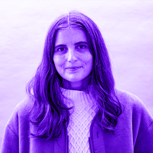 Jimena Paz overlaid with a violet hue. jimena is wearing a white knit sweater and a felt jacket and is smiling. jimena has long hair past the shoulders. 