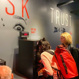 Faculty member Stephanie Reyer and a student look at an interactive exhibit at the International Spy Museum.