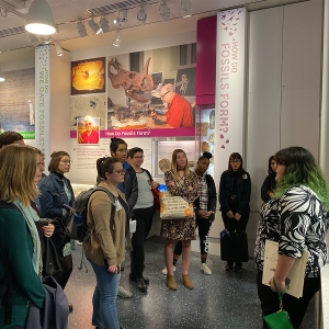 Students gather around a tour guide in the fossil exhibit at the Smithsonian National Museum of Natural History