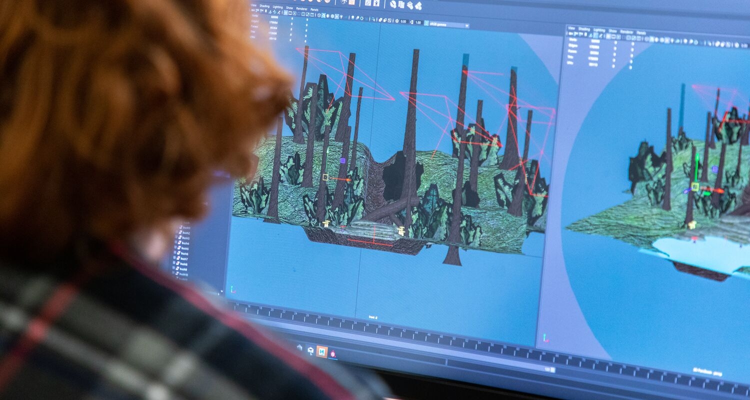 A student works on their game art on a computer.