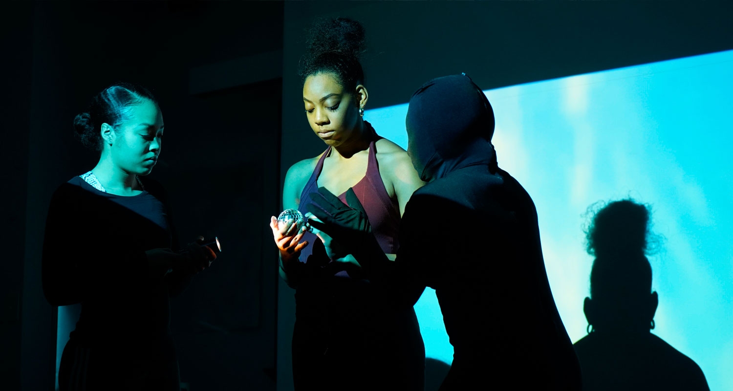 UArts students perform during an annual show against a blue screen set