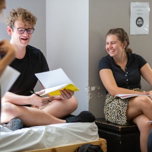 Theater students discuss their scripts in the classroom